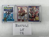 Three cards in screw-down acrylic holders side by side with lot label