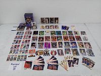 Wide view showing the full assortment of basketball cards laid out including the Yao Ming rookie card set in a collectible tin, Michael Jordan cards and various others.