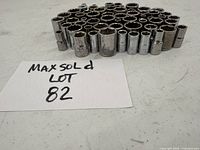 Front view of a set of 59 chrome sockets arranged standing upright showing sizes and openings.