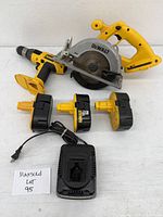 Yellow Dewalt circular saw along with cordless drill, 3 batteries and charger, all arranged for overview.