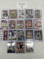 Grid of 20 football cards in sleeves on table