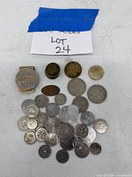 Overall assortment of foreign coins and tokens showing variety in size and metals