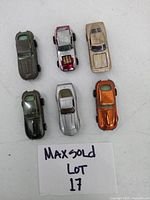 Top-down view of six vintage diecast cars laid out in two rows