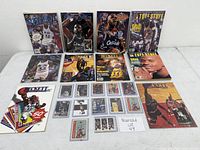 Overview of eight magazines on top two rows, one promotional sheet and trading cards below