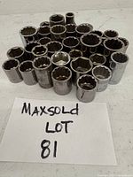 Photo showing an arranged group of 32 Craftsman sockets of varied sizes, with visible etching of size and brand on each socket.