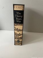 Spine of the slipcase showing the title 'The Thirty Years War' with detailed historical illustration around it.