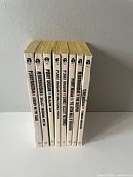 Eight Perry Rhodan paperback books lined up showing spines with titles and series numbers.
