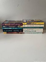 Stack of 10 sci-fi paperback books with spine titles visible.