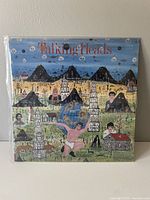 Front cover of Talking Heads Little Creatures album sleeve with colorful illustrated artwork.