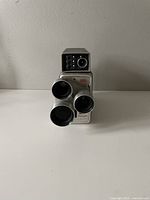 Front view of Kodak Brownie 8mm movie camera showing triple lenses and top viewfinder.