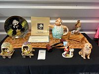 Full lot showing panda plate, teddy bear teapot, music box with rocking horse, and various Easter-themed figurines including bunnies, chicks, girl with lamb, and dog.