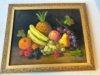 Full image of the framed oil painting showing various fruits including pineapple, bananas, grapes, orange, pear, peach, raspberries, and blackberries, with signature visible.