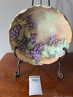 Front view of the grape-themed porcelain punchbowl with hand-painted decoration and gold scalloped rim.