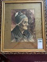 Full view of watercolor portrait of an elderly woman in a gold frame with an ornate design and some damage.