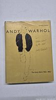 Front cover of the Andy Warhol art book with illustration and title
