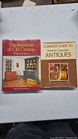 Front covers of two hardcover books about Canadian antique furniture and antiques.