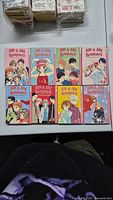 Top-down photo showing eight "Me & My Brother" manga volumes 1 to 8 laid out on a white surface, each with bright anime character covers.
