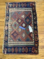Full top view of the folded small area rug showing geometric patterns and color scheme.