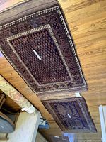 Both rugs laid flat on wooden floor showing overall condition and pattern similarity