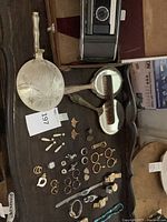 Overall lot: camera, lidded dish, mirrors, comb and assorted jewelry displayed on wooden tray