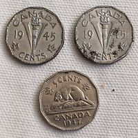 Obverse and reverse of two 1945 Canadian 5-cent coins and one 1947 beaver design coin