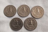 Five USA quarters arranged in two rows; top row shows the eagle reverse design. Coins appear circulated with varying levels of wear and tarnish.