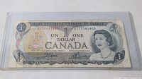 Full front view of the 1973 Canadian 1 dollar bill in protective sleeve showing overall condition and design.