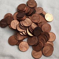 Pile of mixed condition USA one-cent coins showing Lincoln Memorial reverse and Lincoln obverse