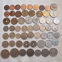 Top view of all 57 coins arranged in rows showing size and color variety.