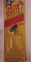 Photo of Another Martin brand Amazing Sonic Spinner fishing lure in original sealed packaging with treble hook, red and yellow packaging