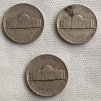 Three USA 1962 nickel coins showing the Monticello building on the reverse sides with 'E PLURIBUS UNUM, MONTICELLO, FIVE CENTS, UNITED STATES OF AMERICA' inscriptions.