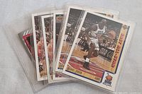 Six Michael Jordan basketball cards in protective sleeves, fanned out to show some detail.