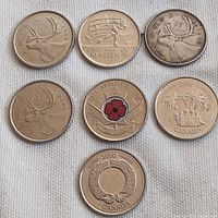 Photo showing all 7 Canadian quarters with mixed commemorative designs.