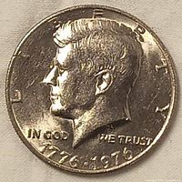 Obverse side of the 1976 USA half dollar coin showing the profile of John F. Kennedy.
