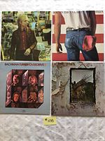 Full view of all four vinyl LP records with covers: Tom Petty and the Heartbreakers, Bruce Springsteen, BTO, Led Zeppelin. Shows original album covers in good condition.