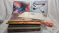 Stack of vinyl records showing album covers including Harry Chapin Live, Canada Centennial Song, and other albums