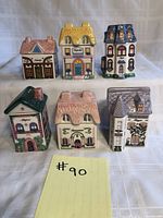 Front view of six Avon Spice Houses showing different architectural styles and colors with spice names on the front.