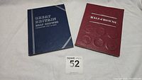 Two coin albums: blue album titled 'Great Britain Half Crowns Collection 1941 to Date' and red album titled 'Half-Crowns'.