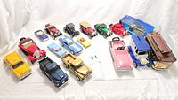Wide angle photo of all 15 model cars in the lot including variety of vintage cars, musical trolley, and kiddie cars.