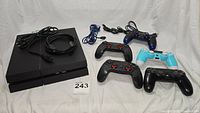 Overview of PS4 console, five controllers and cables