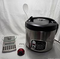 Photo showing set of Aroma rice cooker, ladybug timer, and Beurer kitchen scale on white backdrop