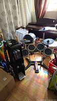 Overall view of Rock Band drum kit, cymbals and nearby guitars