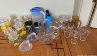 Overview photo of all kitchen ware items including storage jars, pitchers, drinking glasses and heart-shaped dishes.
