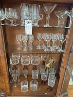 Full glass cabinet display with multiple types and sizes of stemware