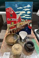 Full arrangement showing large coastal village ceramic tile and four varied ceramic containers in front.