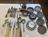 Full lot overview showing all silverware, serveware, and containers arranged on table