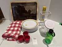 Photo of plastic serveware, fabric tablecloth and decorative tray