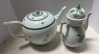 Both teapots shown side by side on surface