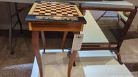 Full view of the vintage wooden chess table with curved legs and inlaid chessboard top with decorative border.