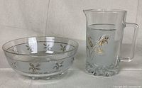 Clear glass bowl featuring frosted horizontal band with gold wheat designs, footed base